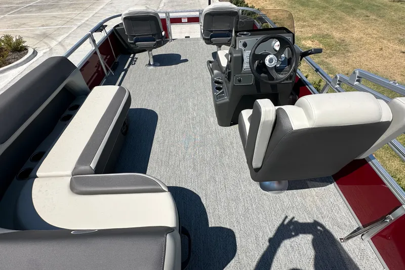 Slide: The Image of 2026 Sun Tracker Bass Buggy 18 DLX pontoon boat interior with seating and steering console. - 33