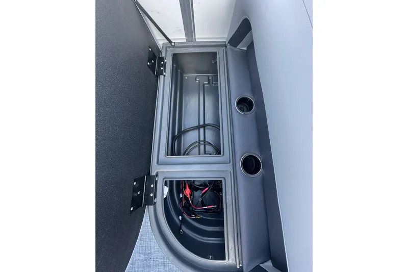 Slide: The Image of Storage compartment of 2026 Sun Tracker Party Barge 16 DLX with cup holders and wiring. - 21