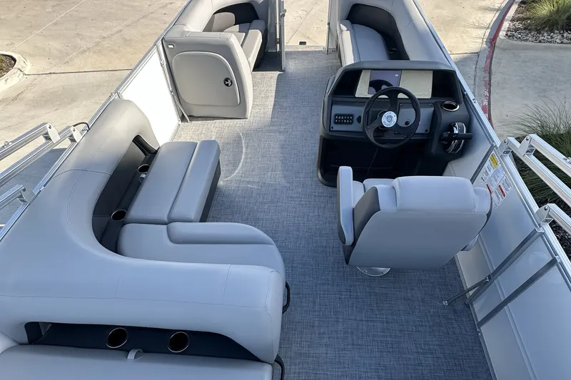Slide: The Image of 2026 Sun Tracker Party Barge 16 DLX interior with seating and helm station. - 16