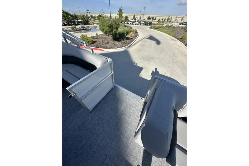 Slide: The Image of 2026 Sun Tracker Party Barge 16 DLX interior with open gate and seating. - 13