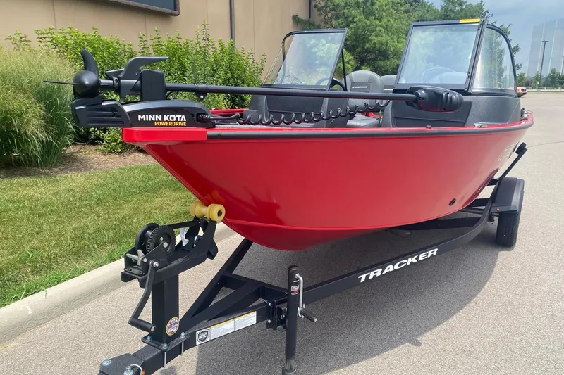 Slide: The Image of 2026 Tracker Pro Guide V-16 WT boat on trailer, featuring Minn Kota PowerDrive motor. - 2