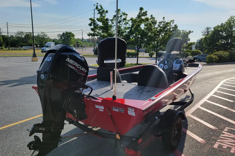 Slide: The Image of 2026 Tracker Pro Team 175 boat with Mercury engine in parking lot. - 2