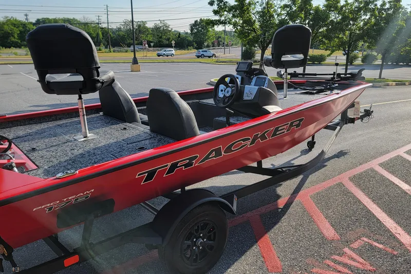 Slide: The Image of 2026 Tracker Pro Team 175 boat in parking lot, featuring red exterior and dual seating. - 3
