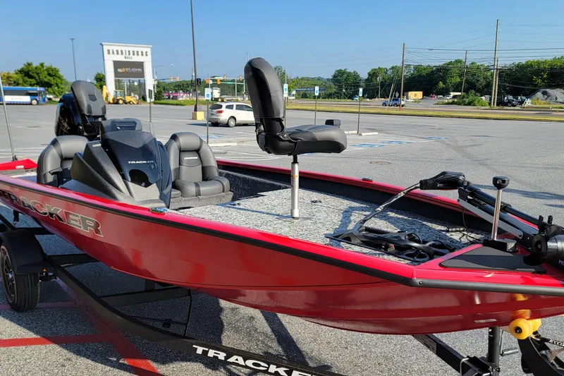 Slide: The Image of 2026 Tracker Pro Team 175 boat in parking lot, featuring sleek red design and modern seating. - 4
