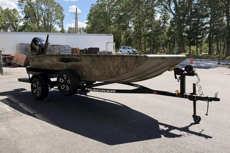 The Image of 2026 Tracker Grizzly 1650 T Prairie Wings Edition boat on trailer in outdoor setting. - 0