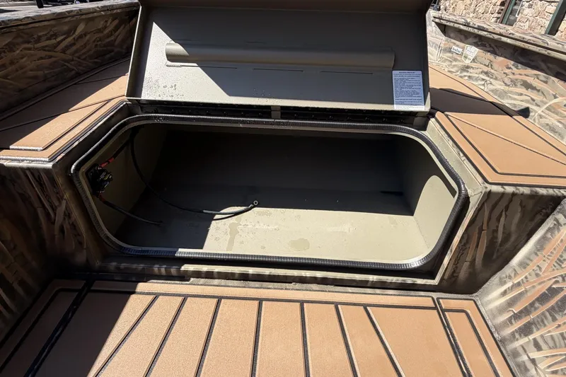 Slide: The Image of Open storage compartment in 2026 Tracker Grizzly 1650 T Prairie Wings Edition boat. - 2