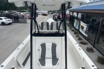 Slide: The Image of 2026 Ranger 2360 Bay boat with sleek design and comfortable seating, displayed outdoors. - 2