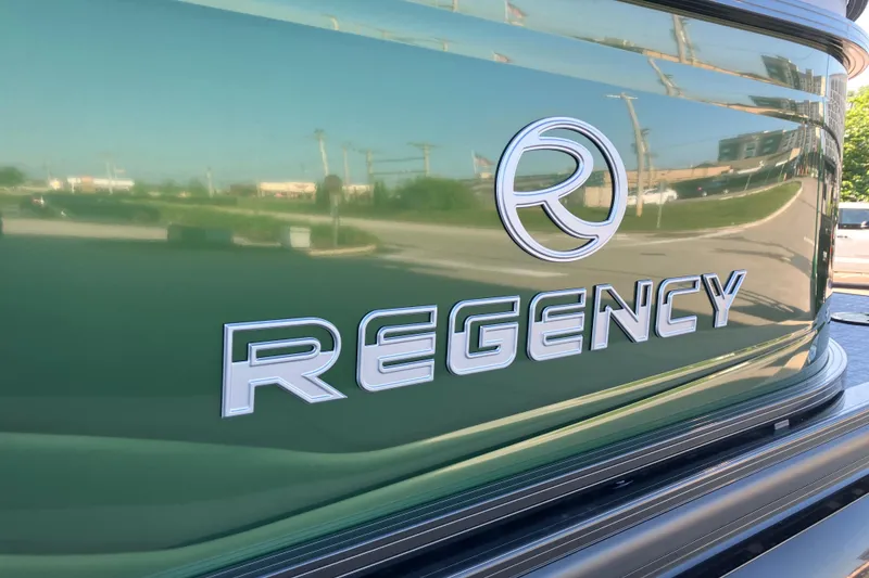 Slide: The Image of 2026 Regency 230 DL boat with reflective green finish and logo. - 3