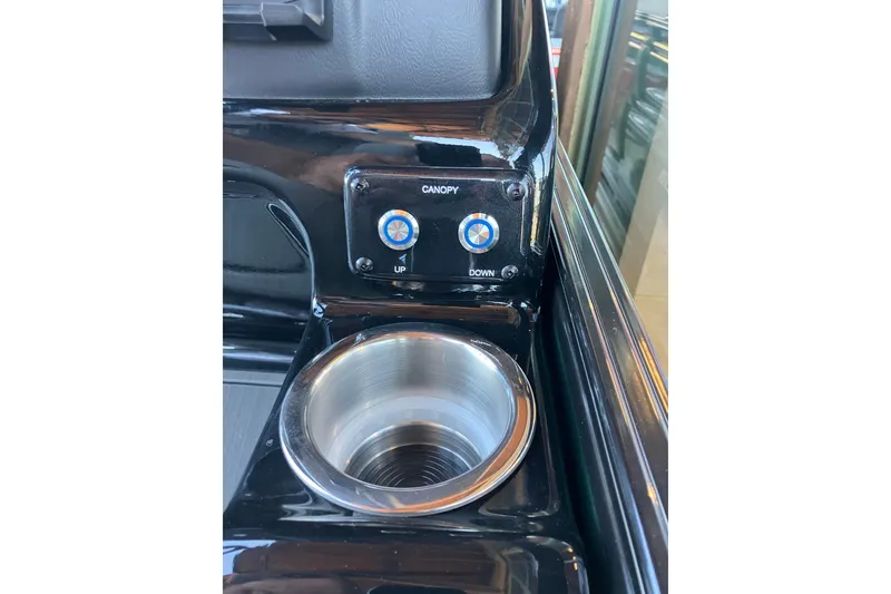 Slide: The Image of Control panel and cup holder in 2026 Regency 230 DL boat. - 12