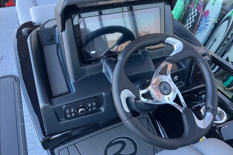 Slide: The Image of Steering console of 2026 Regency 230 DL boat with modern controls and touchscreen display. - 11