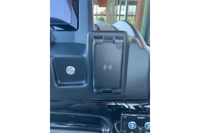 Slide: The Image of Dashboard of 2026 Regency 230 DL with wireless charging pad and control buttons. - 13