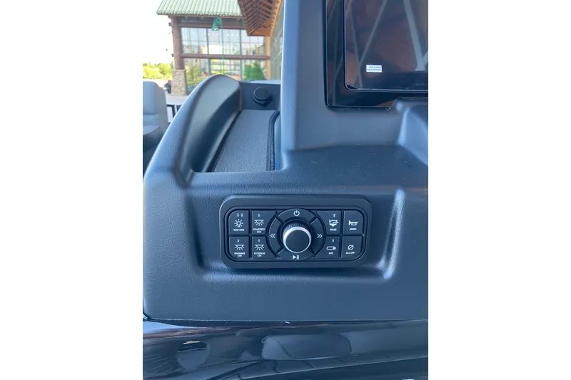 Slide: The Image of Control panel of 2026 Regency 230 DL boat with various function buttons. - 14