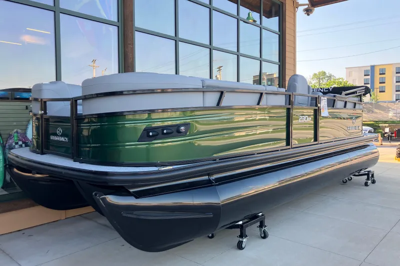 The Image of 2026 Regency 230 DL pontoon boat displayed outdoors, featuring sleek green and black design. - 0