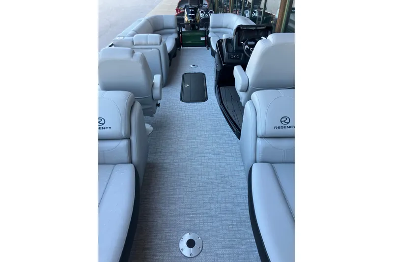 Slide: The Image of Interior view of 2026 Regency 230 DL pontoon boat with luxurious seating and modern design. - 7