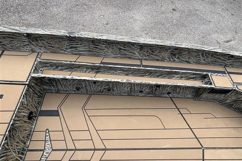Slide: The Image of 2026 Tracker Grizzly 1756 T Marsh boat interior with camouflage design and textured flooring. - 10