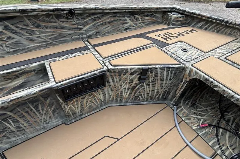 Slide: The Image of 2026 Tracker Grizzly 1756 T Marsh boat interior with camo design and storage compartments. - 12