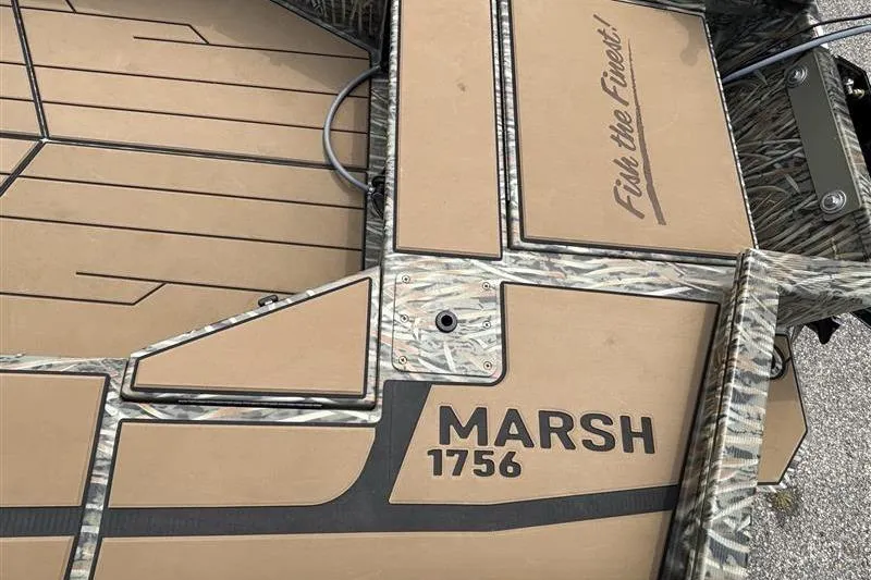 Slide: The Image of 2026 Tracker Grizzly 1756 T Marsh boat deck with camouflage design and "Fish the Finest" slogan. - 11