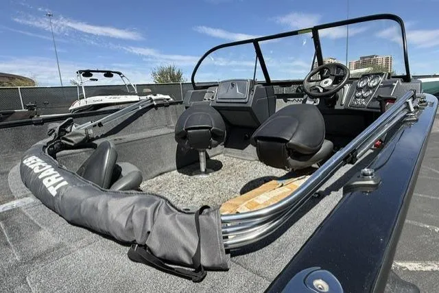 Slide: The Image of 2025 Tracker Pro Guide V-175 WT boat interior with steering console and seating. - 3