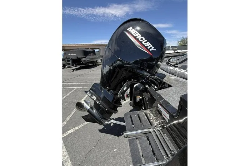 Slide: The Image of 2025 Tracker Pro Guide V-175 WT with Mercury outboard motor in parking lot. - 6