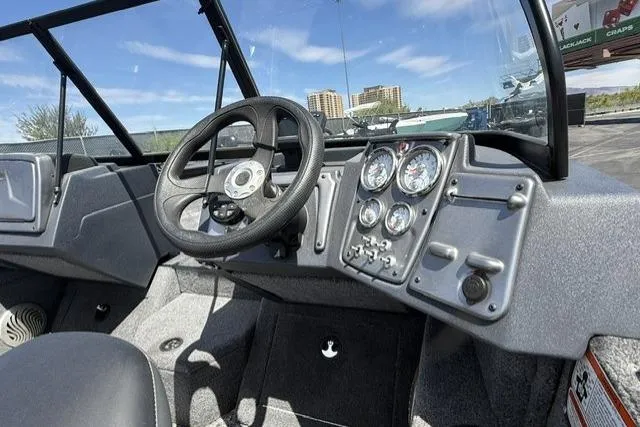 Slide: The Image of 2025 Tracker Pro Guide V-175 WT boat dashboard with steering wheel and gauges. - 5