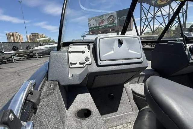 Slide: The Image of 2025 Tracker Pro Guide V-175 WT boat interior with dashboard and seating, under clear blue sky. - 8