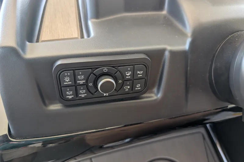 Slide: The Image of Control panel of 2026 Regency 230 DL boat with various function buttons. - 13