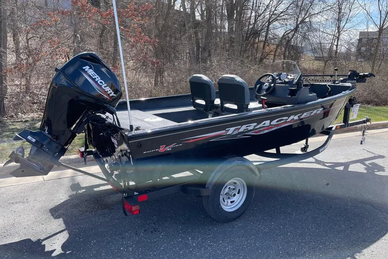 The Image of 2026 Tracker Super Guide V-16 SC boat with Mercury engine on a trailer. - 0