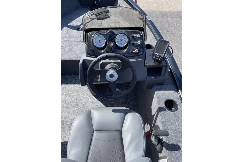 Slide: The Image of 2026 Tracker Super Guide V-16 SC boat dashboard with steering wheel and gauges. - 44