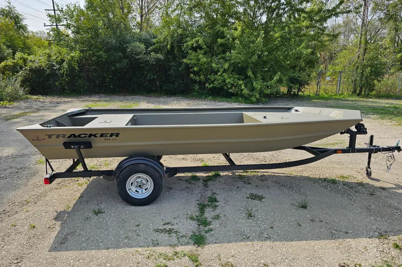The Image of 2026 Tracker Grizzly 1754 Utility boat on trailer, parked outdoors. - 0