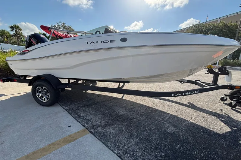 Slide: The Image of 2026 Tahoe T18 boat on trailer under sunny sky. - 6