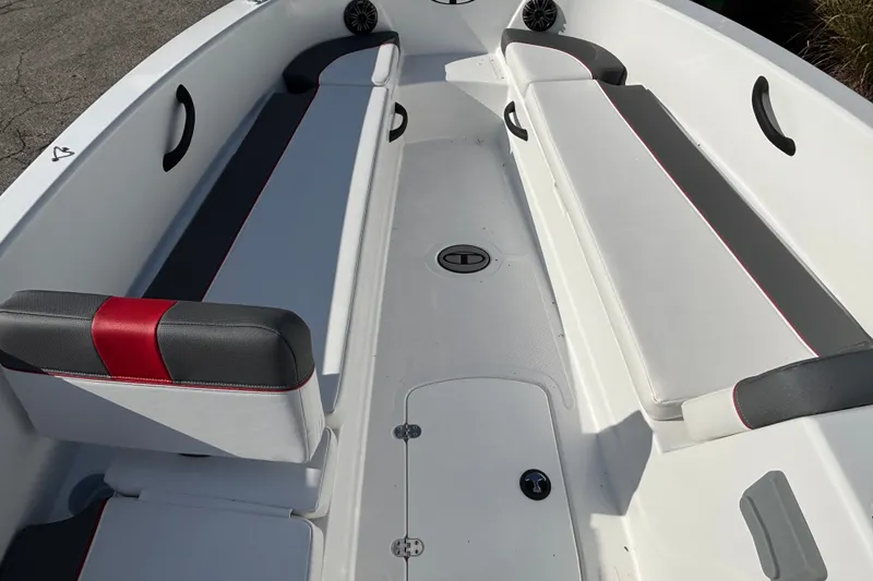 Slide: The Image of 2026 Tahoe T18 boat interior with white and gray seating, red accents, and storage compartments. - 12