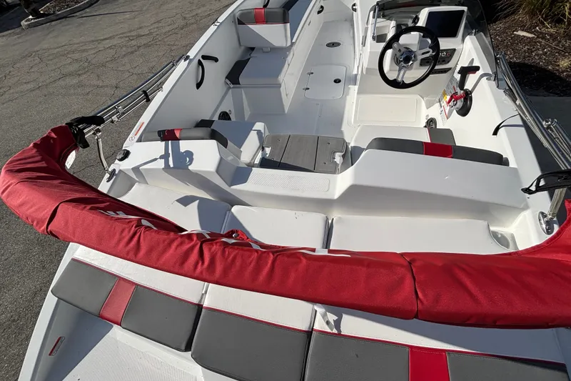 Slide: The Image of 2026 Tahoe T18 boat interior with red and gray seating, steering wheel, and control panel. - 9