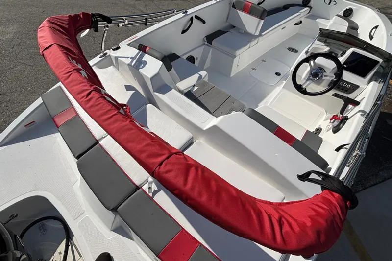Slide: The Image of 2026 Tahoe T18 boat interior with red and gray seating, steering wheel, and controls. - 8