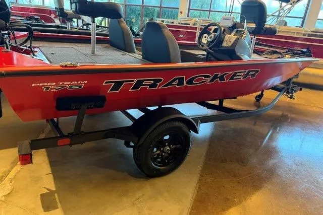 The Image of 2026 Tracker Pro Team 175 boat in showroom, red exterior, on trailer. - 0