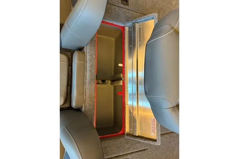 Slide: The Image of Interior storage compartment of 2026 Tracker Pro Team 175 boat, featuring gray seating and red trim. - 13