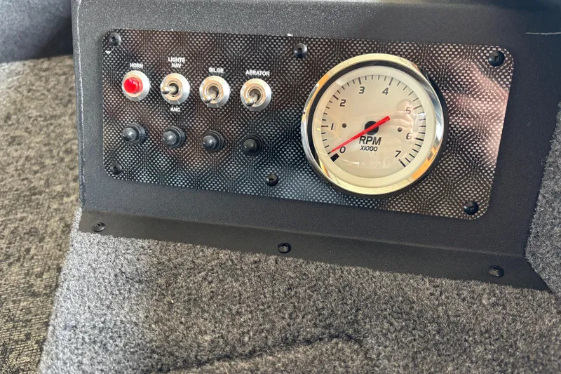 Slide: The Image of Control panel of 2026 Tracker Super Guide V-16 T with RPM gauge and switches. - 6