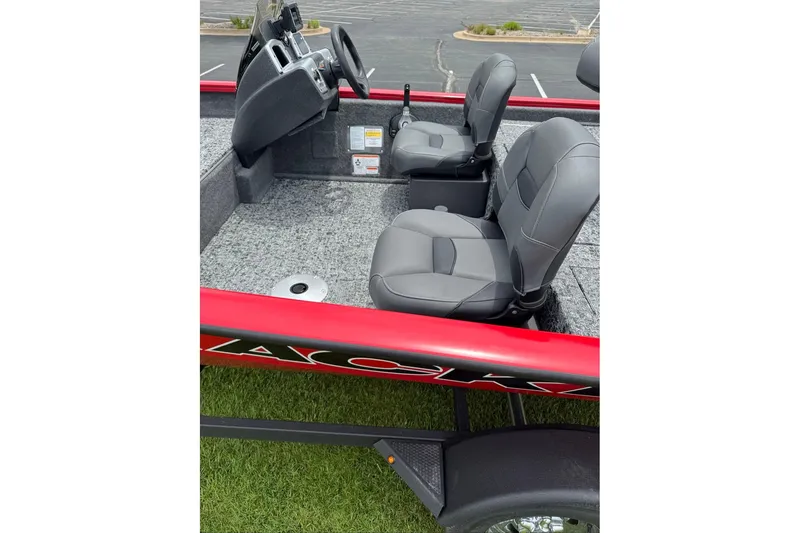 Slide: The Image of 2026 Tracker Pro Team 175 Crappie Edition boat interior with gray seats and steering console. - 6