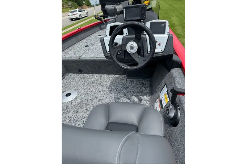 Slide: The Image of 2026 Tracker Pro Team 175 Crappie Edition boat interior with steering wheel and controls. - 8