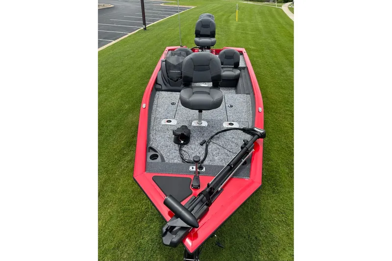 Slide: The Image of 2026 Tracker Pro Team 175 Crappie Edition boat with red exterior on grass. - 9
