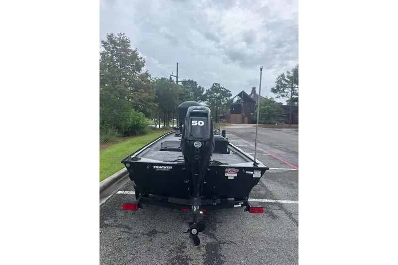 Slide: The Image of 2026 Tracker Pro 170 boat with Mercury 50 engine in a parking lot. - 2
