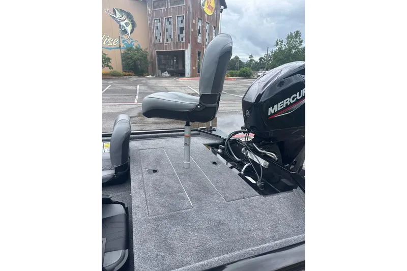Slide: The Image of 2026 Tracker Pro 170 boat with Mercury engine, parked near a building. - 6