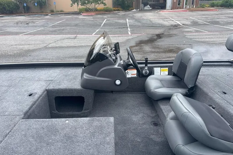 Slide: The Image of 2026 Tracker Pro 170 boat interior with gray seating and steering console. - 5