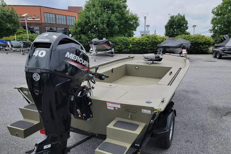 Slide: The Image of 2026 Tracker Grizzly 1654 T Sportsman boat with Mercury 40 engine in outdoor showroom. - 2