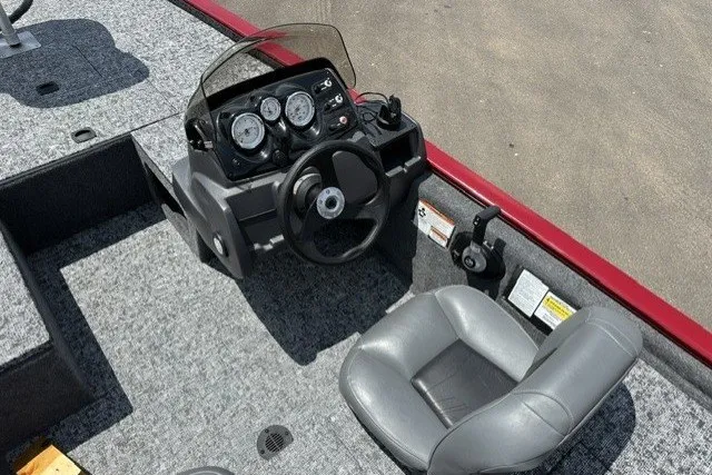 Slide: The Image of 2026 Tracker Pro 170 boat cockpit with steering wheel and gauges, featuring gray seating. - 18