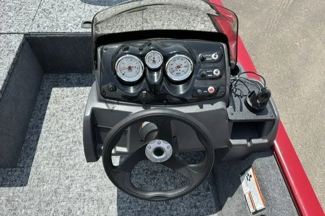 Slide: The Image of 2026 Tracker Pro 170 boat dashboard with steering wheel and gauges. - 16