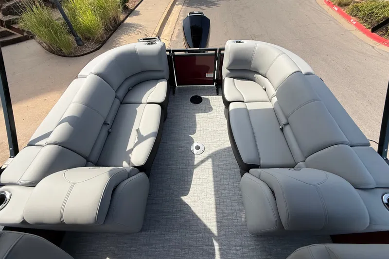 Slide: The Image of Luxurious seating on 2026 Regency 230 DL pontoon boat, featuring spacious, comfortable gray upholstery. - 14