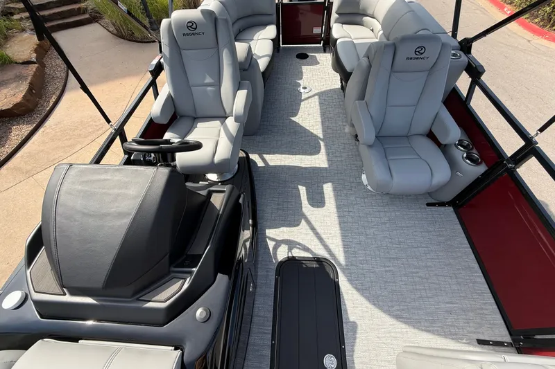 Slide: The Image of 2026 Regency 230 DL pontoon boat interior with luxurious seating and modern helm. - 13
