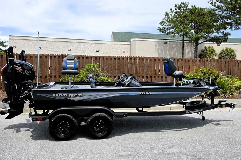 Slide: The Image of 2026 Ranger RT188P fishing boat on trailer, parked outdoors, featuring sleek design and modern equipment. - 1