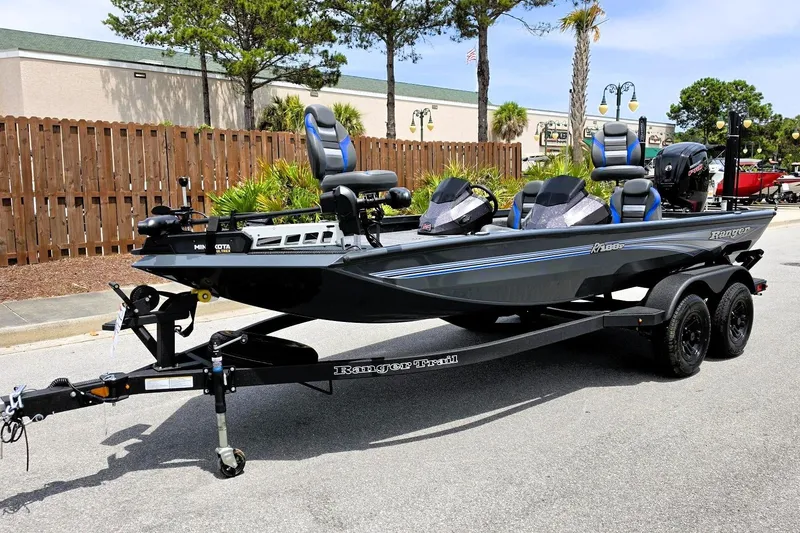 Slide: The Image of 2026 Ranger RT188P fishing boat on trailer, parked outdoors, featuring sleek design and modern equipment. - 11