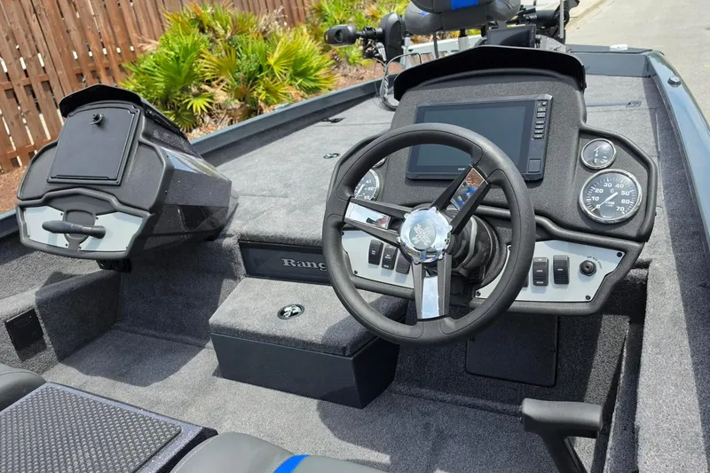 Slide: The Image of 2026 Ranger RT188P boat dashboard with steering wheel, gauges, and control panel. - 13